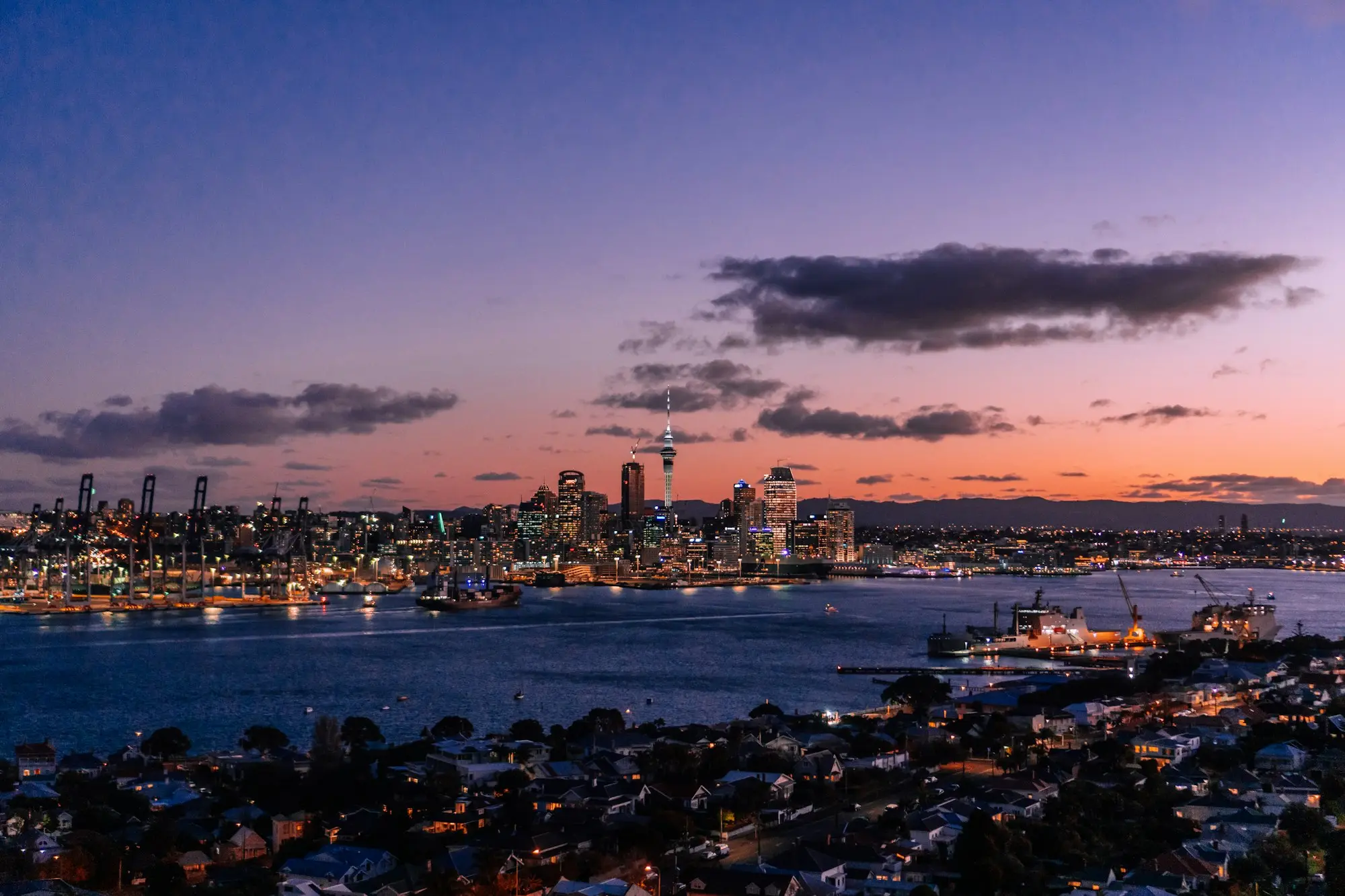 Auckland city skyline under a cloudy sky