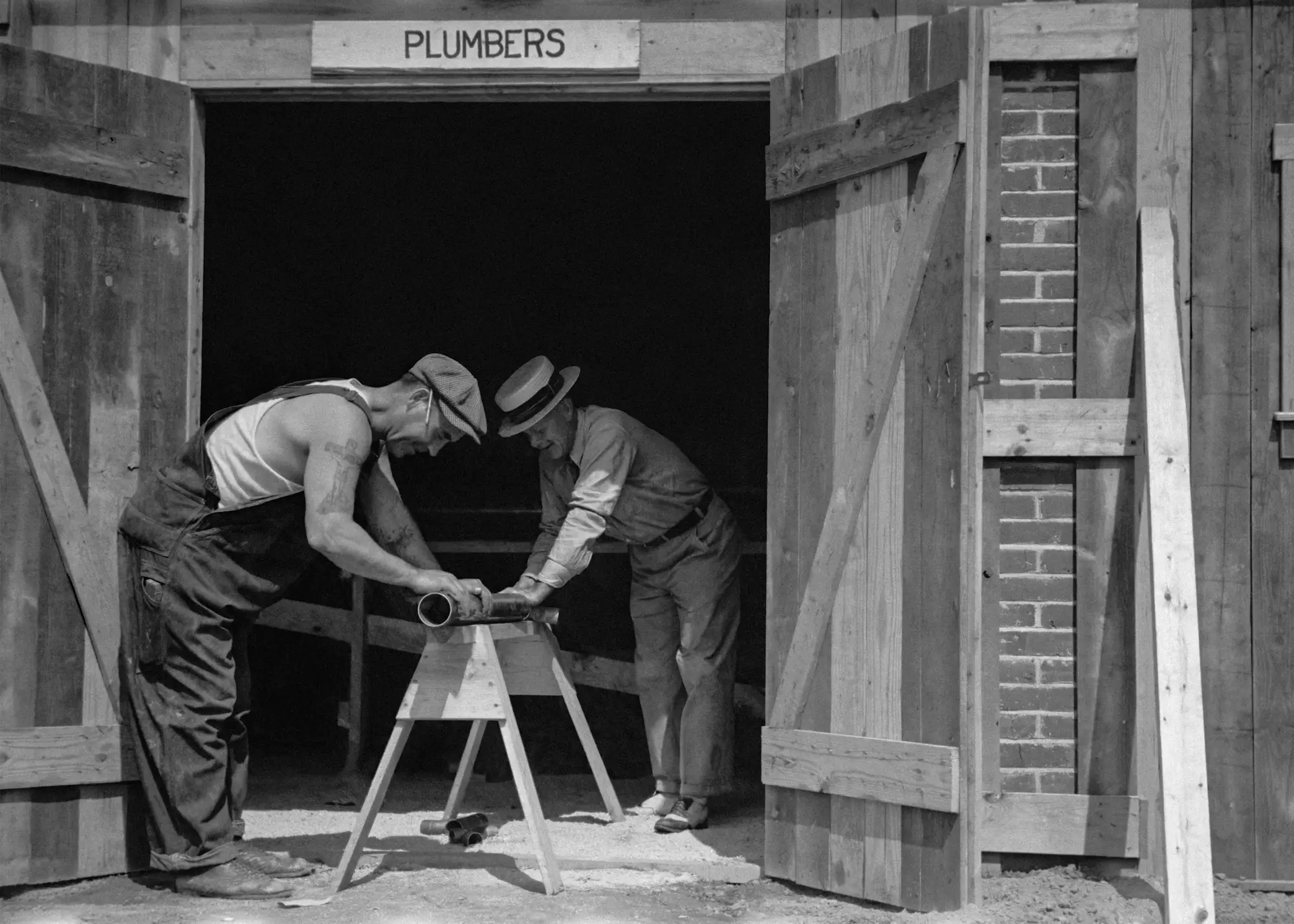 Two builders working on a timber frame on site